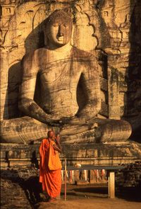 Sri Lanka - a monk prays at the famous statue of Buddha