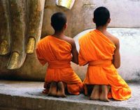 Sukhothai - Buddhist novices praying at the large Buddha