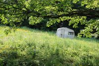 Wales - An old caravan, which has seen better days, left to rest in a secluded field